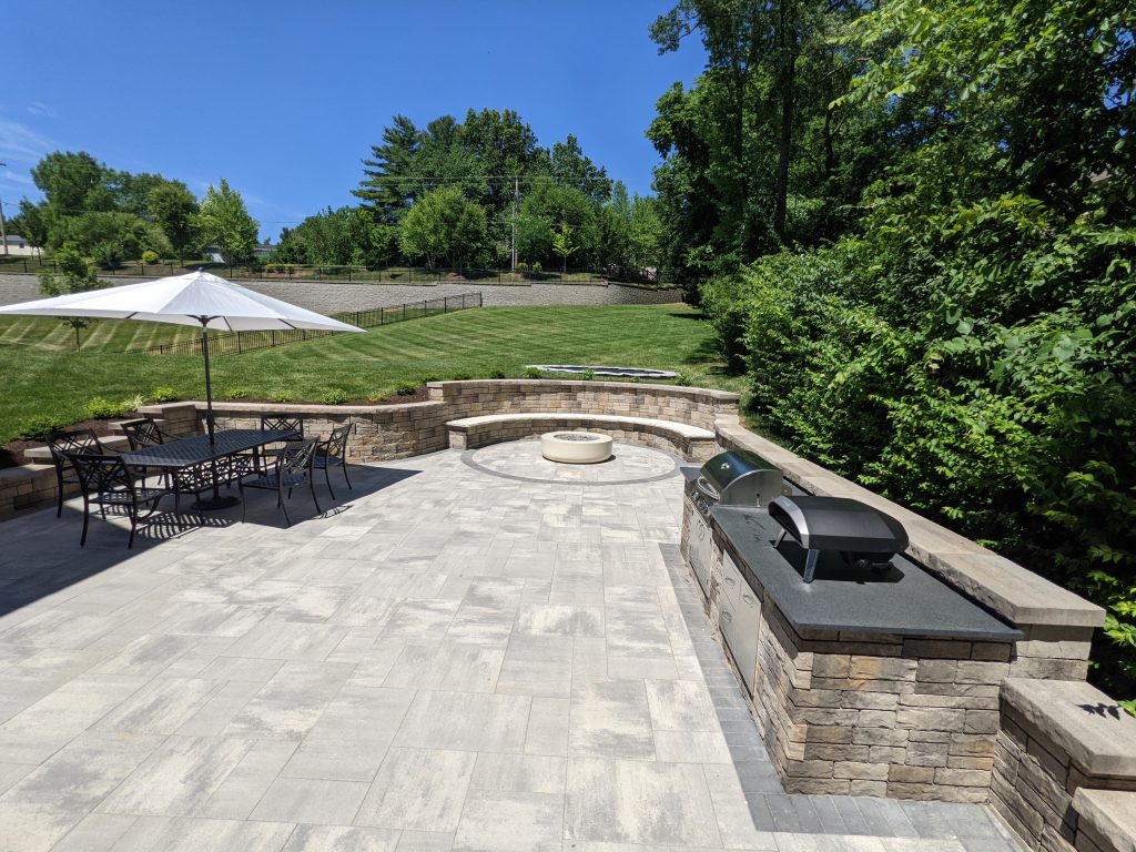 Outdoor Paver Patio installed Belgard pavers and retaining walls with built-in trampoline