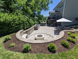 paver patio, fire pit and outdoor grill island by Quiet Village