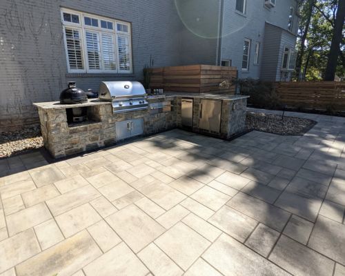 Primo outdoor grill with granite countertops and modern patio