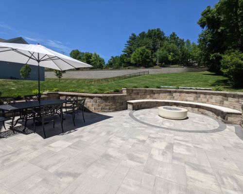 patio installation with a fire pit for a backyard makeover