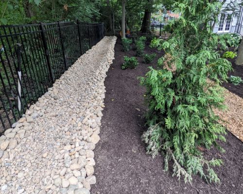 water runoff landscape design with river rock